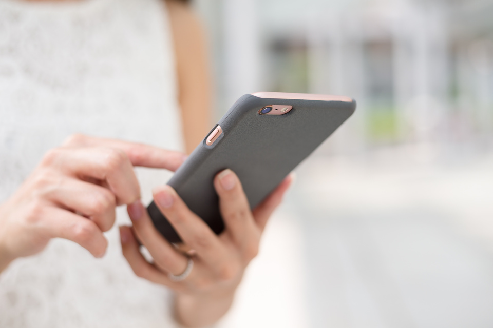 Woman Sending Message on Smart Phone