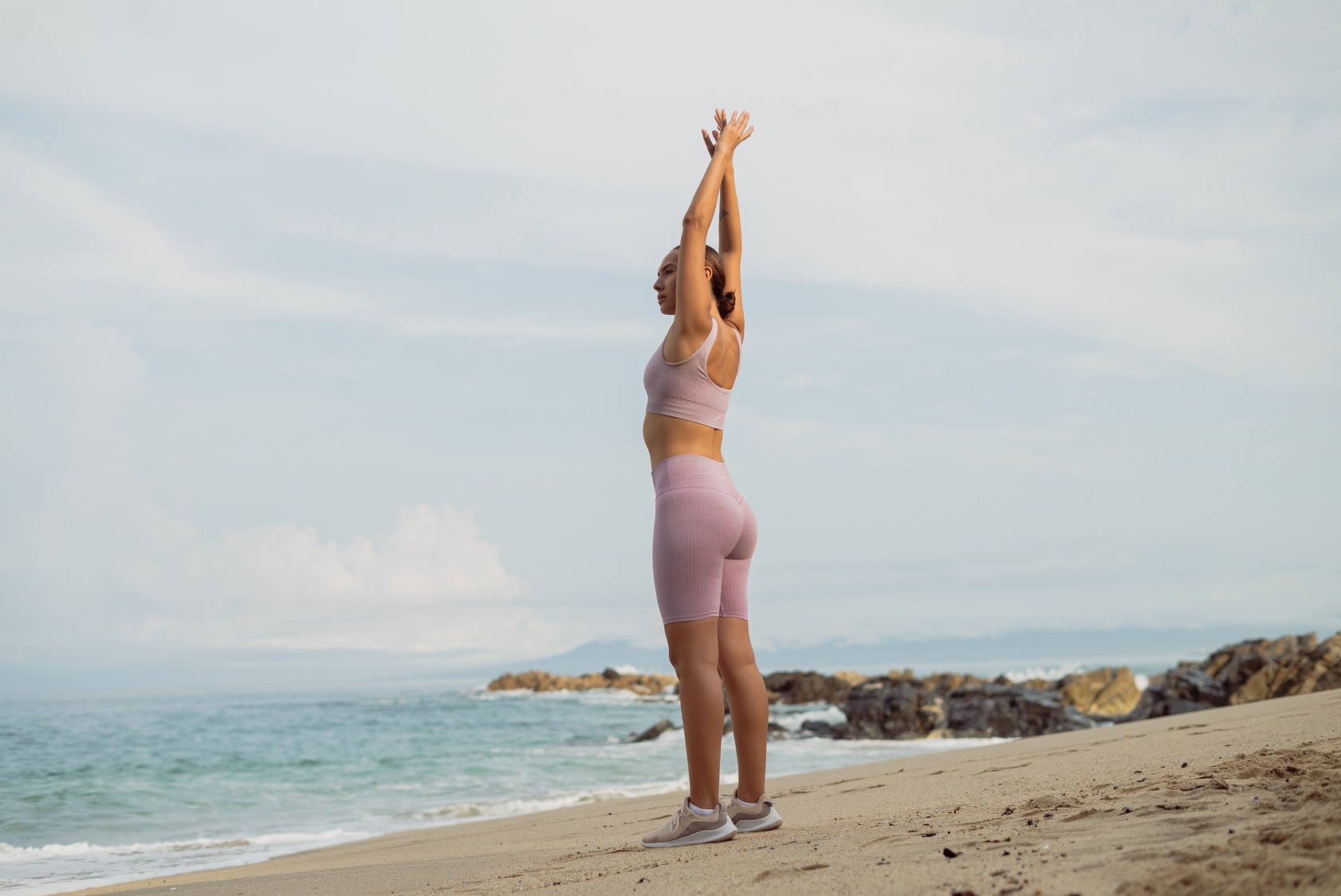 Fit Woman Stretching on Beach